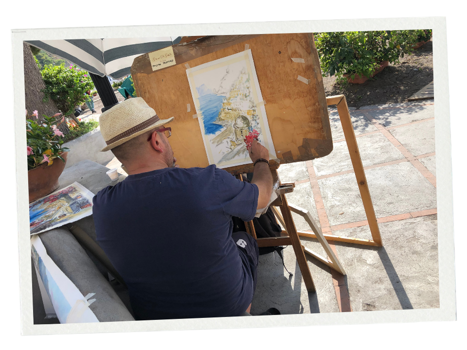 A street artist paints a view of Positano.
